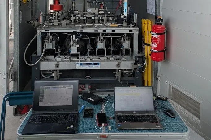 Open dispenser cabinet with measurement laptops during a site acceptance test